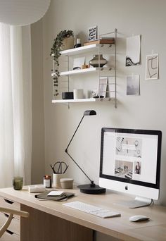 a computer monitor sitting on top of a wooden desk