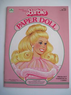 the barbie paper doll book is laying on the floor next to it's packaging