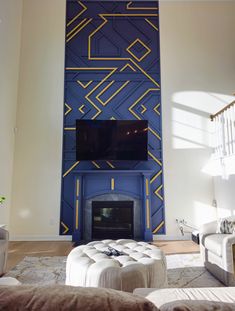 the living room is decorated in blue and yellow with an abstract design on the wall