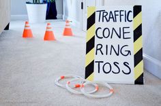 a traffic cone ring toss sign sitting on the floor