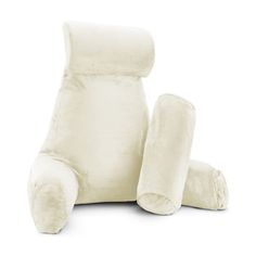 a white stuffed animal sitting on top of a pillow