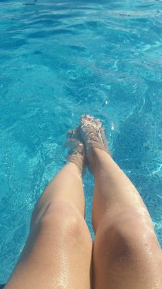 a woman's legs in the clear blue water