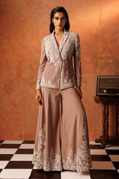 Sand drift padded blazer with floral, cutdana, pearl, sequin embroidery and geometric pattern texture. Paired with a flared pant, elevated with floral embroidery. Comes along with an inner padded bustier. - Aza Fashions Elegant Fitted Pant Set With Intricate Embroidery, Elegant Fitted Palazzo Set With Set-in Sleeves, Fitted Pant Set With Intricate Embroidery For Wedding, Elegant Fitted Pant Set With Dupatta, Elegant Fitted Pant Set For Designer Wear, Fitted Palazzo Set With Resham Embroidery For Formal Occasions, Formal Fitted Palazzo Set With Intricate Embroidery, Formal Fitted Pant Set With Resham Embroidery, Fitted Pant Set For Eid Reception