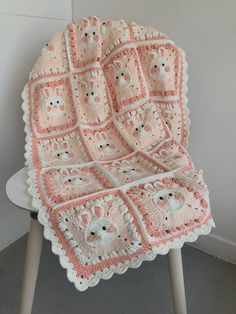 a crocheted blanket sitting on top of a chair