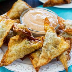 some fried food on a plate with dipping sauce