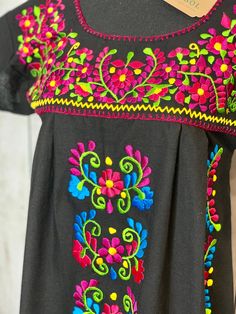 Black Floral Manta Mexican Dress. Beautiful embroidery can be dressed up or wear with sandals. Please feel free to contact us with any questions. Measurements upon request. Traditional Black Embroidered Dress For Fiesta, Black Embroidered Dress For Summer, Traditional Black Embroidered Beach Dress, Traditional Black Embroidered Dress For Beach, Black Embroidered Dress For Fiesta With Floral Details, Black Embroidered Dress For Fiesta, Embroidered Dress For Fiesta And Festivals, Mexican Dresses, Beautiful Embroidery