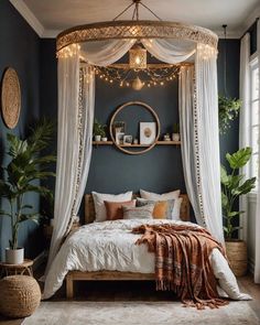 a canopy bed with white drapes and lights hanging from it's sides in a bedroom