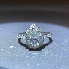 a close up of a diamond ring on a table