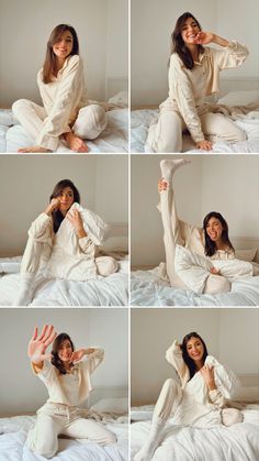 a woman in white pajamas sitting on top of a bed with her hands up to her face