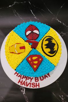 a birthday cake decorated with superheros and the words happy bday havish