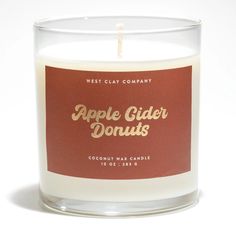 an apple cider donuts candle sits in front of a white background with the words west clay company on it