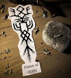 a sticker with the word vision of odin on it next to a rock