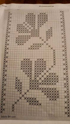 a cross - stitch pattern on top of a piece of paper