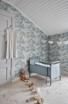 a baby's room with blue and white wallpaper