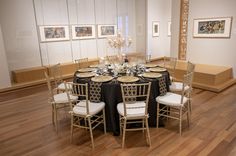 a dining room table is set with black and white linens for an elegant dinner