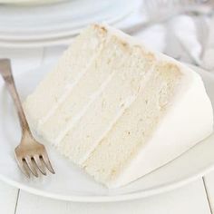 a slice of white cake on a plate with a fork