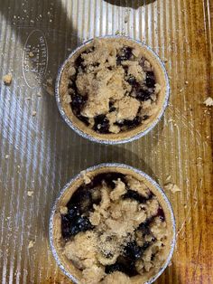 two blueberry pies sitting on top of a table