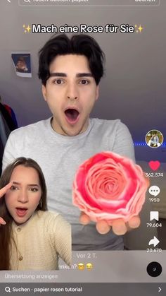 two people are making funny faces and one is holding a fake flower in front of the camera