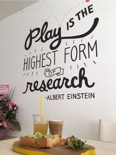 there is a sign on the wall that says play is the highest form of research