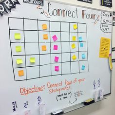 a white board with sticky notes attached to it