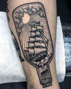 a ship in a bottle tattoo on the leg