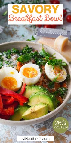 a bowl filled with eggs, peppers and avocado on top of a table