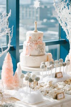 a table topped with lots of different types of cakes and desserts covered in frosting