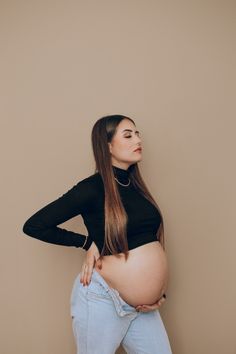 a pregnant woman with her hands on her hips