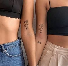 two women with matching tattoos standing next to each other