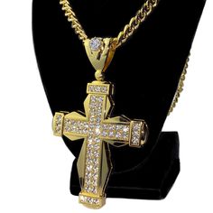 Huge iced cross pendant hip hop chain. 30" x 8mm cuban chain with a lobster lock. 18k gold plated over heavy alloy metal core.. Huge pendant is 5" tall w/bale and 2.75 wide. Pendant iced with dazzling round-cut stones. Sturdy well made pendant has a caged back. Solid piece has good weight at 180 grams. 100% FREE SHIPPING in USA. Order now! Streetwear Jewelry: Cross Pendant Chain, Streetwear Jewelry With Cross Pendant Chain, Streetwear Cross Pendant Chain Jewelry, Gold Iced Out Cross Pendant Jewelry, Gold Iced Out Cross Pendant Necklace, Iced Out Gold Cross Pendant Jewelry, Jesus Gifts, Hip Hop Chains, Cuban Chain Necklace