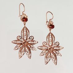 A beautiful and delicate look! This set of dangling earrings feature a floral filigree design with a orange carnelian gemstone at the top! 18K Yellow Gold Plated Bronze 2-1/2"L x 1-3/16"W x 1/4"H Two round 4mm dyed orange carnelian cabochons Backing: French Wire Floral Filigree, Orange Carnelian, Filigree Earrings, Filigree Design, French Wire, Dangling Earrings, Rose Gold Earrings, 4 H, 18k Gold