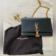 Ysl - Kate Medium Tassel In Grain De Poudre Embossed Leather - Black & Gold Pre-Loved. Comes With Dust Bag. Has Some Very Tiny Scratches That You Have To Look At Very Closely To See But Are Totally Not Noticeable. Definitely A Show Stopper! Bags Ysl, Ysl Kate, Saint Laurent Bags, Yves Saint Laurent Bags, Saint Laurent Paris, Embossed Leather, Emboss, Yves Saint Laurent, To Look