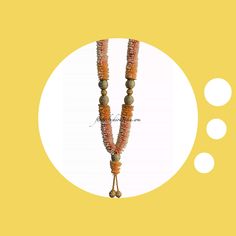 an orange beaded necklace on a yellow background