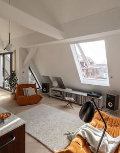 a living room with an orange couch and white rug