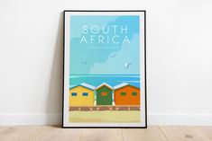 a poster with the words south africa in front of beach huts and seagulls