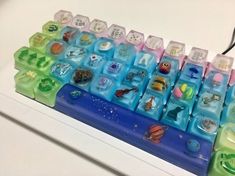 a close up of a computer keyboard on a white surface with lots of different colored keys