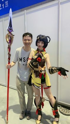 two people standing next to each other in costume