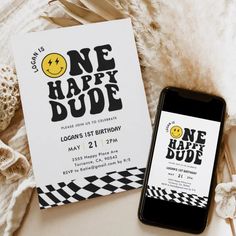 a birthday party with a one happy dude card next to an iphone