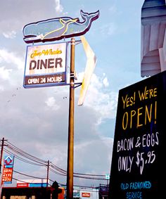 a sign for an old fashioned diner on the corner