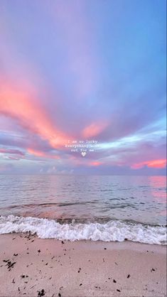 the sky is pink and blue over the ocean