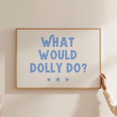 a person holding up a poster with the words what would dolly do?