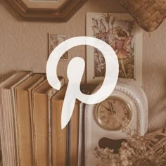 a clock sitting on top of a table next to books