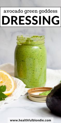 avocado green goddess dressing in a mason jar with an avocado slice next to it