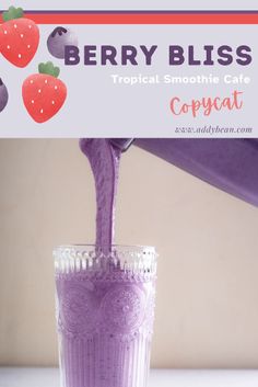 a purple smoothie being poured into a glass with strawberries on the side and text berry bliss tropical smoothie cafe copycat