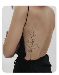 the back of a woman's body with tattoos on it