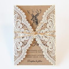 a brown and white wedding card with an antler on it's back, tied in twine