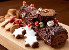 a wooden cutting board topped with lots of different types of food on top of it