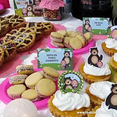 there are many cupcakes and cookies on the table for children's birthday party