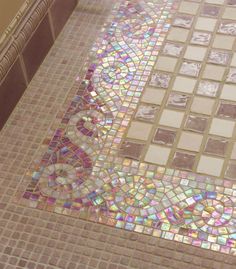 a mosaic tile floor in a bathroom