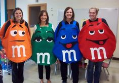 four people are dressed up as m and m